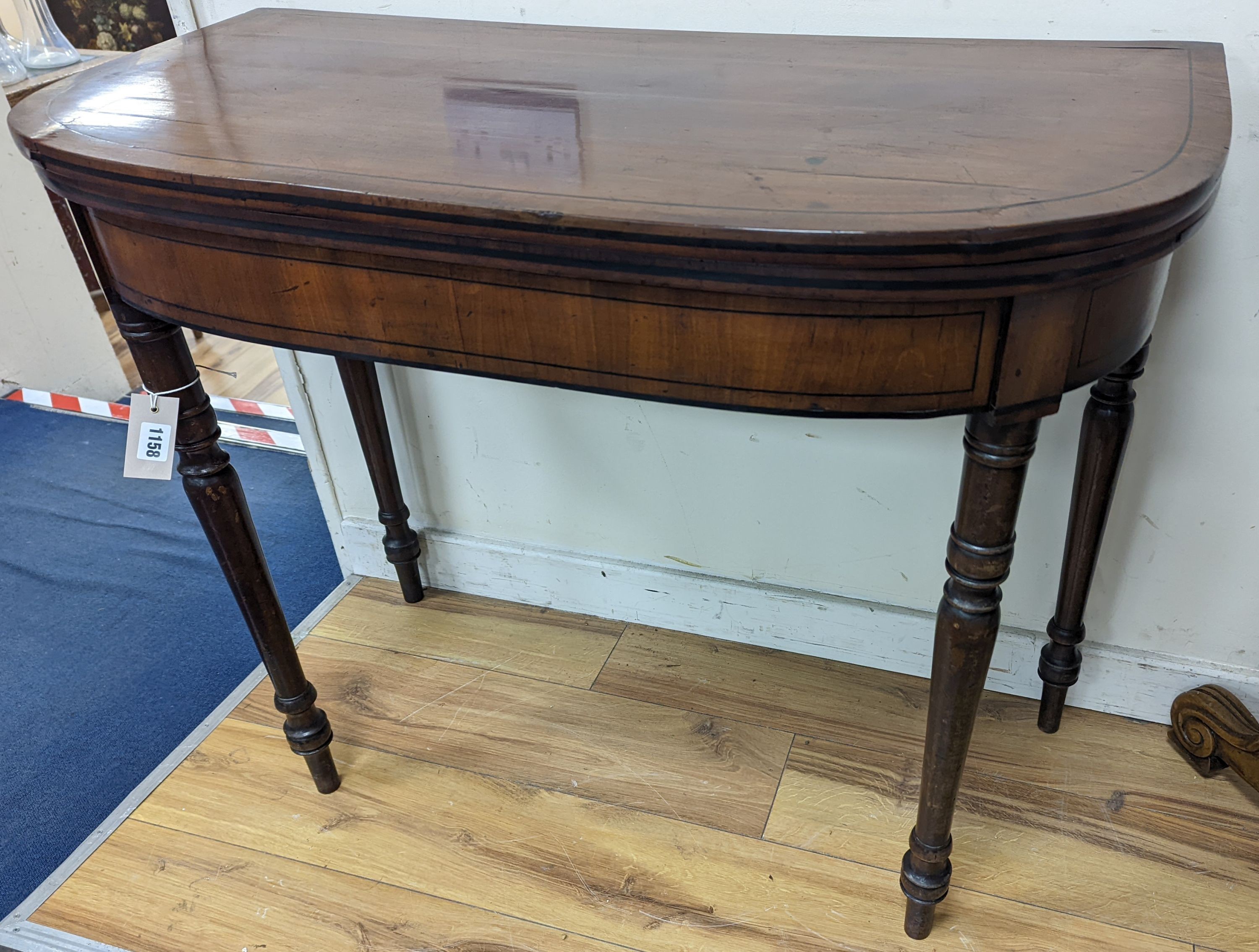 A Regency mahogany D shaped folding card table, width 91cm, depth 46cm, height 74cm